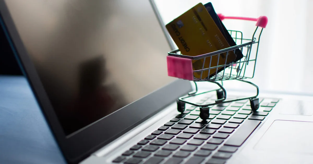 shopping cart and credit card on computer, shopping online concept. subject is blurred and low key.