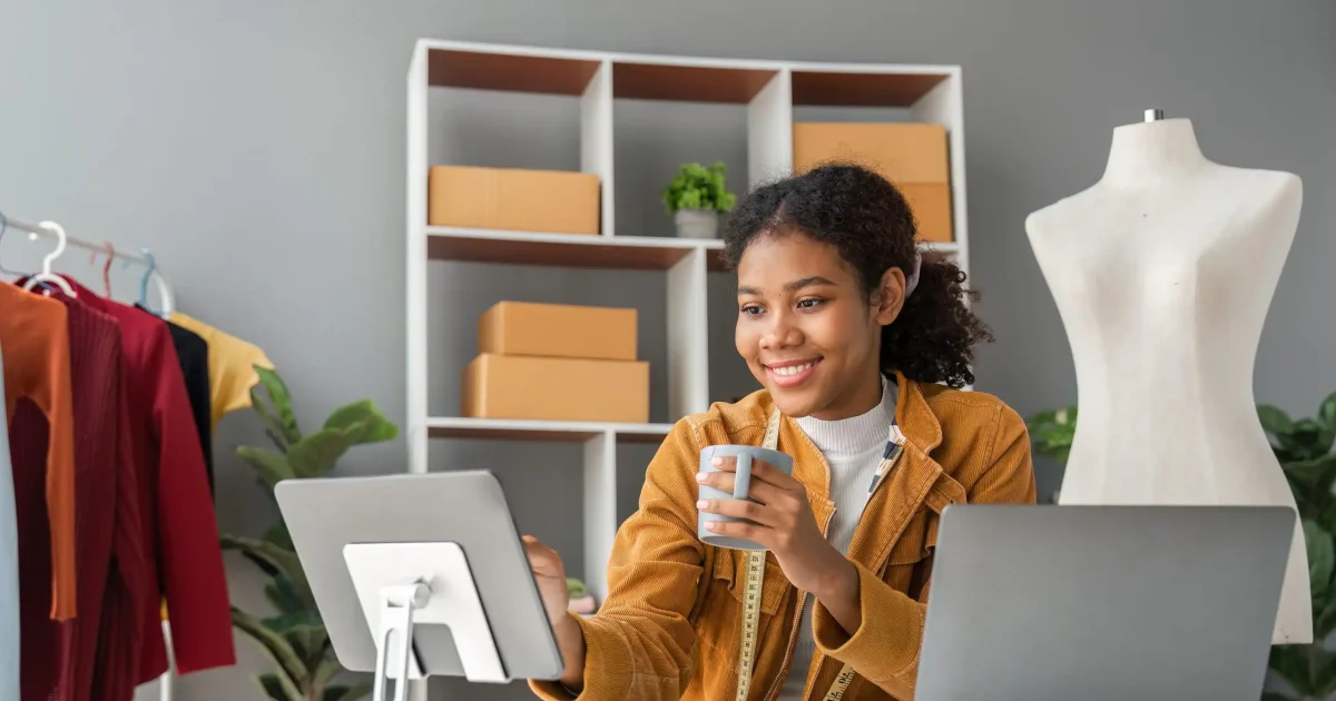 woman telephone and laptop design and shipping an online order sending a package using the internet from her office. technology and logistics with a female entrepreneur at work in her studio.