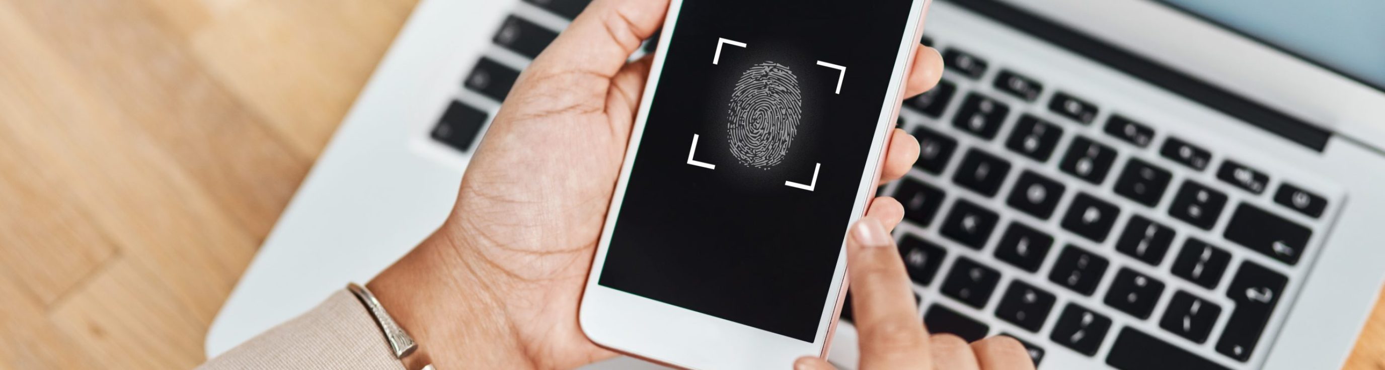 Shot of an unrecognizable businesswoman using a cellphone and laptop in her office.
