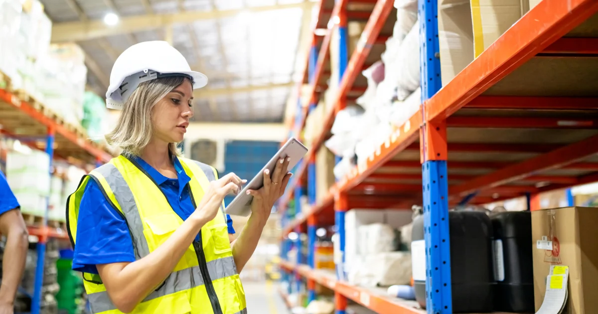 Warehouse workers checking the inventory. Products on inventory shelves storage. Worker Doing Inventory in Warehouse. Dispatcher in uniform making inventory in storehouse. supply chain concept