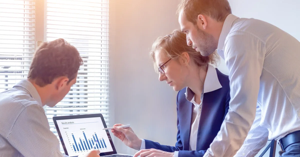 Accounting team discussing financial report data with chart on computer screen in office, consulting people reviewing corporate strategy and business analytics metrics