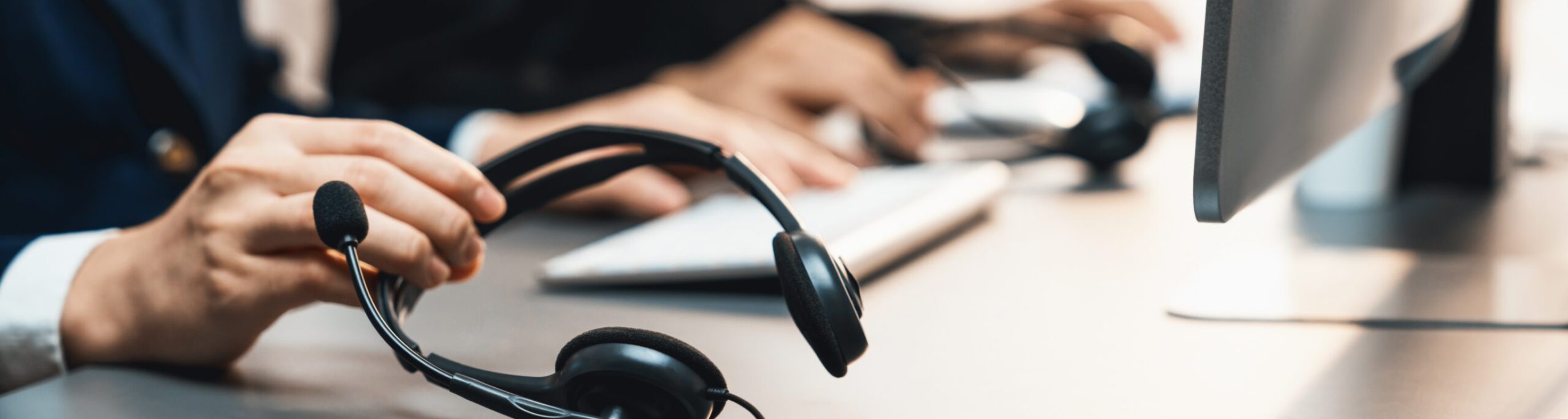 Panorama,Focus,Hand,Holding,Headset,On,Call,Center,Workspace,Desk
