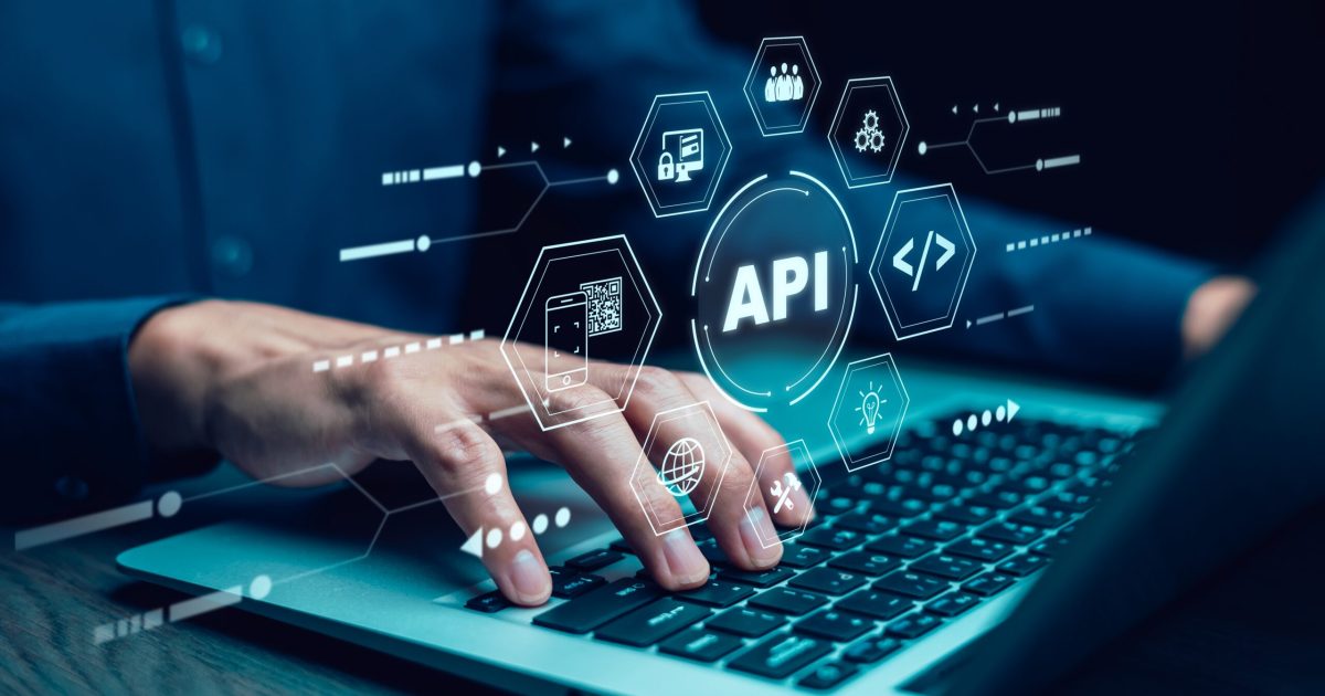 Businessman,Using,Laptop,With,Api,Icon,On,A,Virtual,Screen