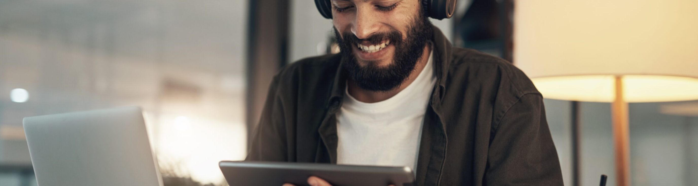 Creative,,Man,And,Smile,With,Tablet,,Laptop,And,Video,Editor